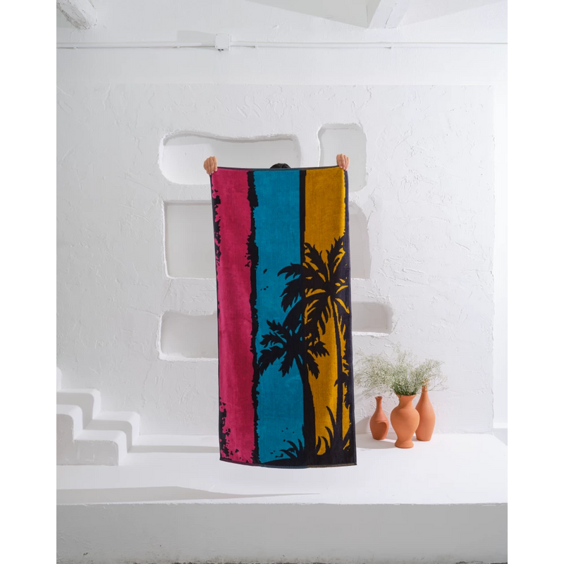 Escape to a lush oasis with this stunning palm tree beach towel.
