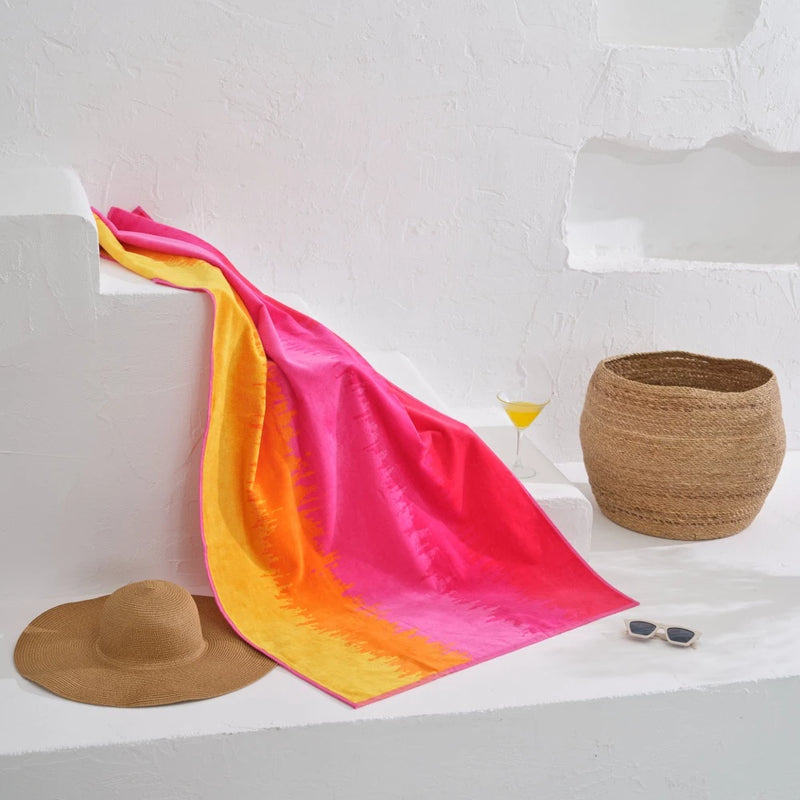 "This cotton towel boasts a stunning ombré hot design that will elevate your beach style."